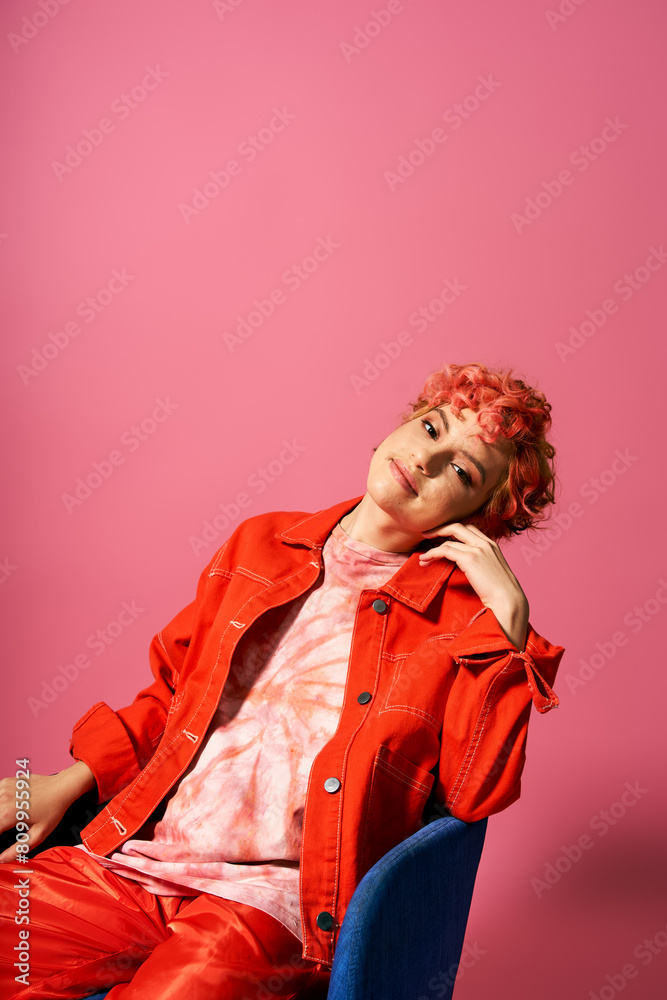 Extraordinary woman with red hair sitting in a blue chair. Extraordinary woman with red hair sitting in a blue chair.