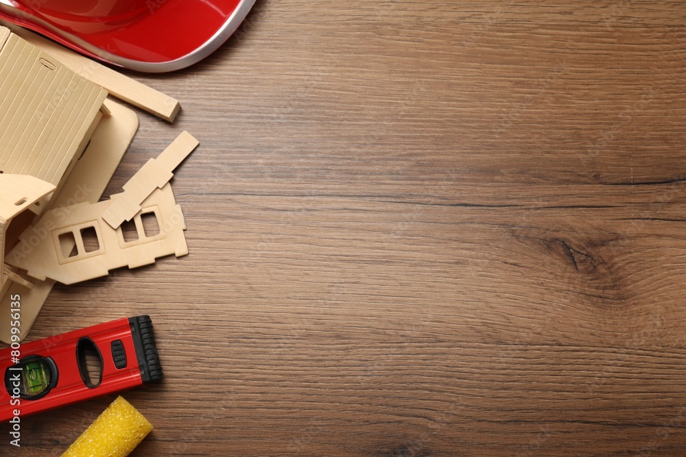 Flat lay composition with building level and other construction tools on wooden table, space for text Flat lay composition with building level and other construction tools on wooden table, space for text