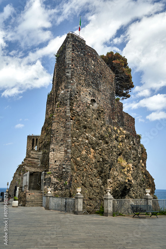Ruins of a Norman castle on a volcanic cliff in the village of Aci Castello on the island of Sicily photo