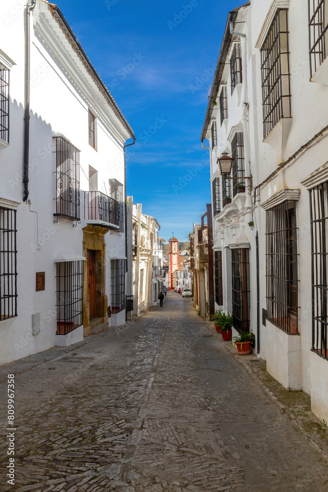 Street of Grazalema in the province of Cadiz and the church of San Juan in the background, Spain