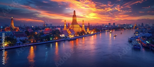 Majestic Wat Arun Temple Rises Elegantly Above Chao Phraya River at Vibrant Sunrise in Bangkok photo