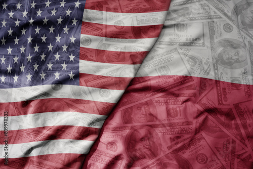 big waving colorful flag of united states of america and national flag of poland on the dollar money background. finance concept.