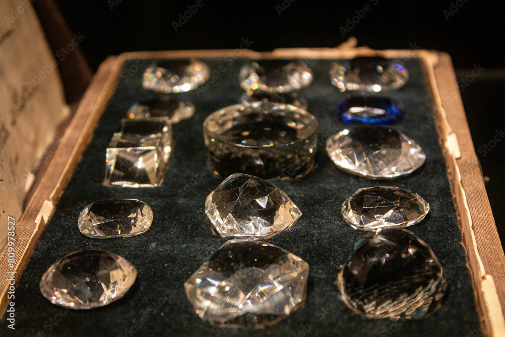 Box with jewelry and crystal transparent stones. Processed clear white quartz amethyst. Close up photo of gemstone background texture