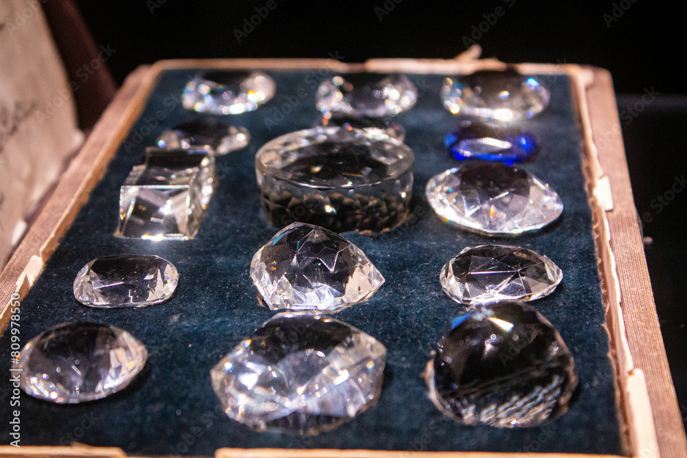 Box with jewelry and crystal transparent stones. Processed clear white quartz amethyst. Close up photo of gemstone background texture Box with jewelry and crystal transparent stones. Processed clear white quartz amethyst. Close up photo of gemstone background texture