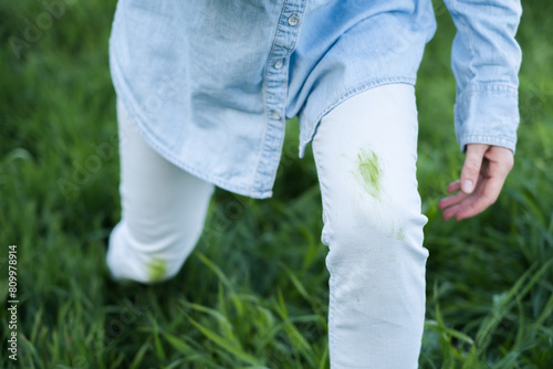 An unrecognizable person showing dirty grass stains on clothes. Spoiled clothes. outdoors.