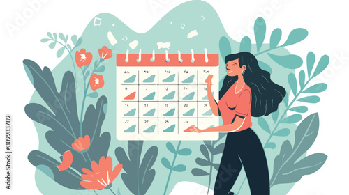 Woman marks the dates of menstruation cycle in the calendar photo