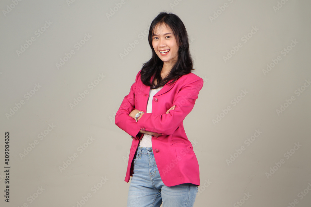 portrait of happy asian business woman wearing pink suit with arm crossed on isolated background portrait of happy asian business woman wearing pink suit with arm crossed on isolated background
