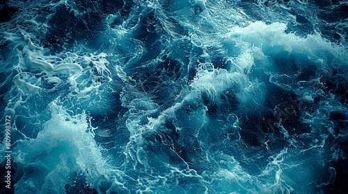  A large body of water covered in numerous foam-topped blue waves