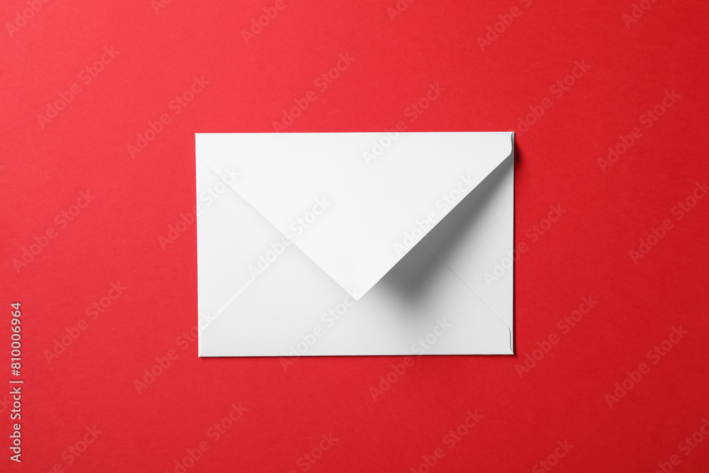 Letter envelope on red background, top view Letter envelope on red background, top view