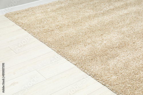 Soft beige carpet on white laminated floor indoors
