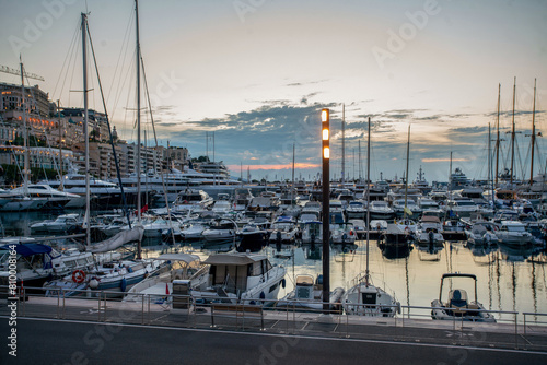 Small boat, middle yachts and larhe yachts across Monte Carlo in Principality of Monaco and buildings of