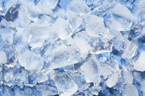 Pieces of crushed ice on light blue background, above view