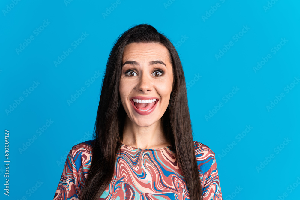 Photo portrait of pretty young girl excited reaction wear trendy colorful clothes isolated on blue color background Photo portrait of pretty young girl excited reaction wear trendy colorful clothes isolated on blue color background