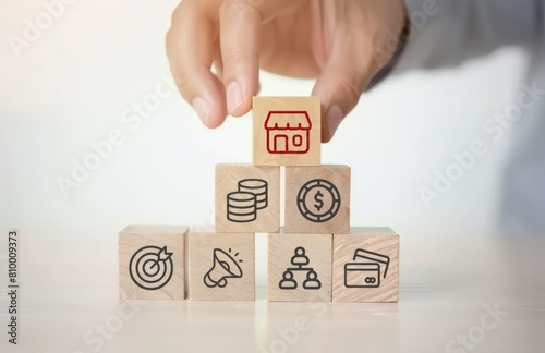 A hand placing wooden cube with shopping cart icons
