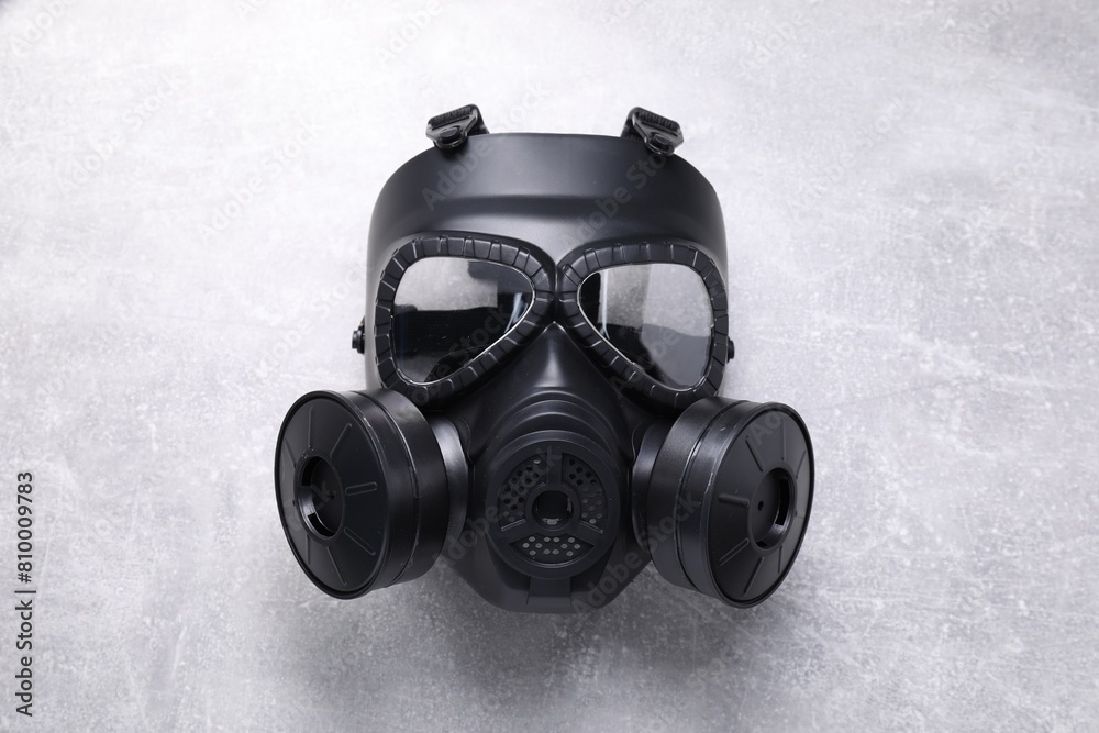 One gas mask on grey textured background, top view One gas mask on grey textured background, top view
