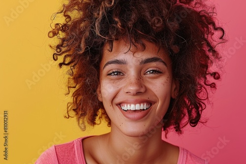A woman with curly hair smiling at the camera. Suitable for lifestyle and beauty concepts