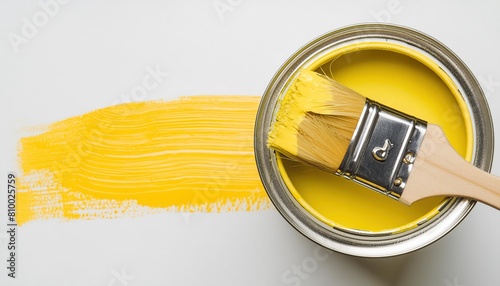 Yellow paint can with paintbrush photo