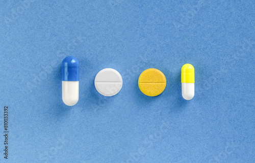 Some pills on blue colored background. Dietary supplements and vitamins