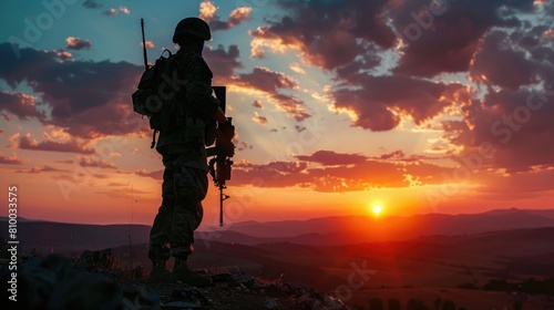 A soldier standing on a mountain with a rifle. Suitable for military or adventure themes