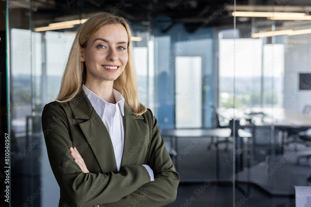 Confident businesswoman standing in modern office Confident businesswoman standing in modern office