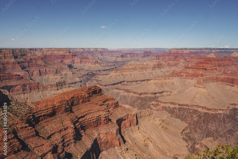 Panoramic view of the Grand Canyon in Arizona, USA, showcasing its colorful layers of sedimentary rock under a clear blue sky. A stunning natural landmark. Panoramic view of the Grand Canyon in Arizona, USA, showcasing its colorful layers of sedimentary rock under a clear blue sky. A stunning natural landmark.