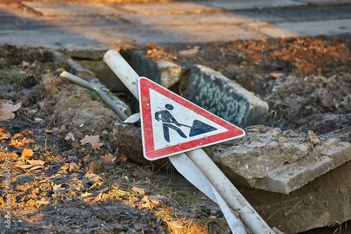 Construction site sign over a utility hole