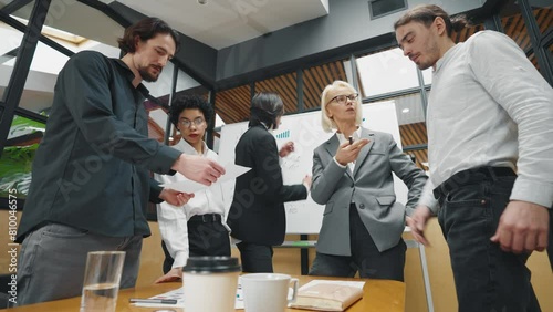 Director accepts work from employees. A woman CEO leader of company reviews the work from employees, solving a problem in board meeting room. Office job, stressed situation, reporting meeting.