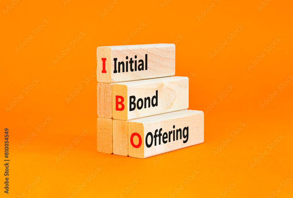 Naklejka premium IBO initial bond offering symbol. Concept words IBO initial bond offering on beautiful wooden blocks. Beautiful orange background. Business IBO initial bond offering concept. Copy space.