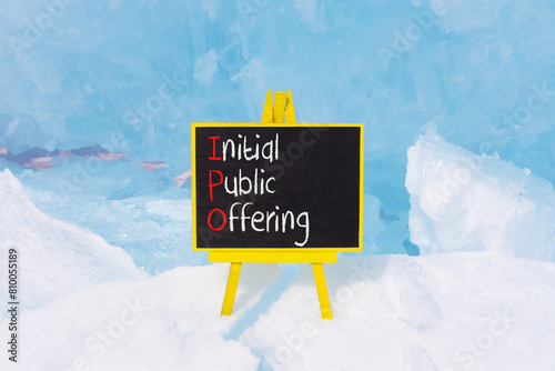 IPO initial public offering symbol. Concept words IPO initial public offering on beautiful yellow blackboard. Beautiful blue ice background. Business IPO initial public offering concept. Copy space.