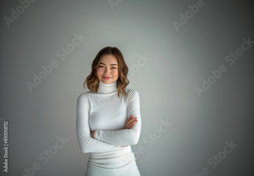 Radiating confidence and beauty, a young Caucasian woman poses in a studio setting, her vibrant smile and trendy style reflecting her joyful and positive outlook on life