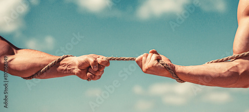 Rescue, help, helping gesture or hands. Conflict, tug of war. Two hands, helping hand, arm, friendship. Hand holding a rope, climbing rope, strength and determination