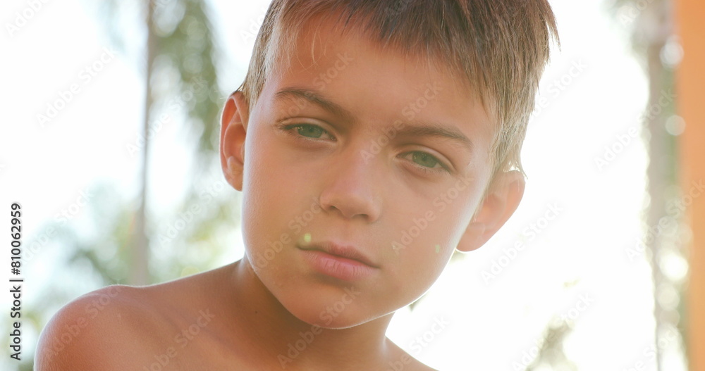 Portrait of serious handsome young boy looking to camera child face looks camera