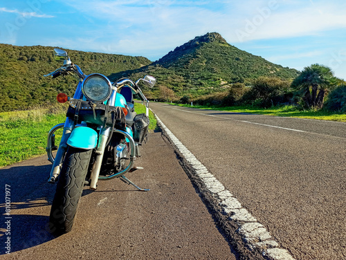 Frontal view of a classic motorcycle on the edge of a country road