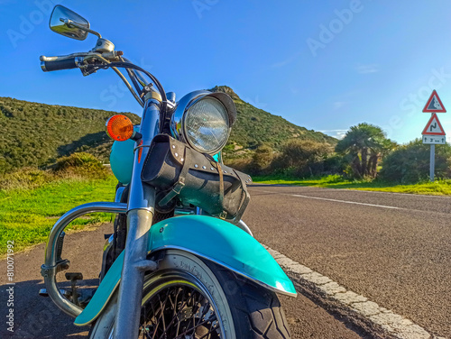 Front view of a classic motorcycle on the edge of a country road