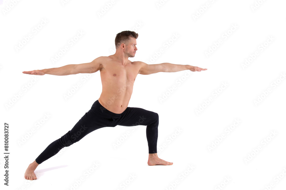 A young attractive man with an athletic body is doing yoga. White background.