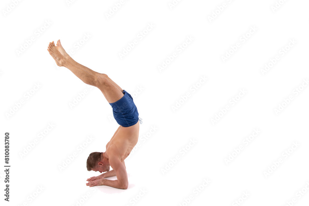 A young attractive man with an athletic body is doing fitness. White background. A young attractive man with an athletic body is doing fitness. White background.