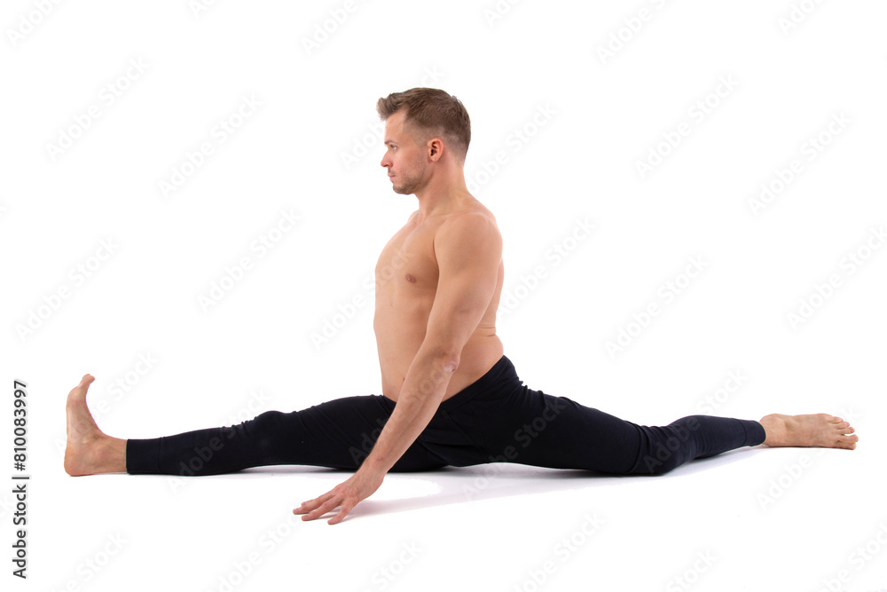 A young attractive man with an athletic body is doing fitness. White background. A young attractive man with an athletic body is doing fitness. White background.