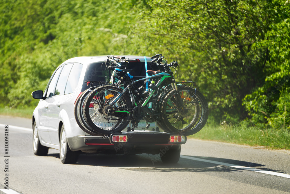 car with two road bicycles loaded on a rack