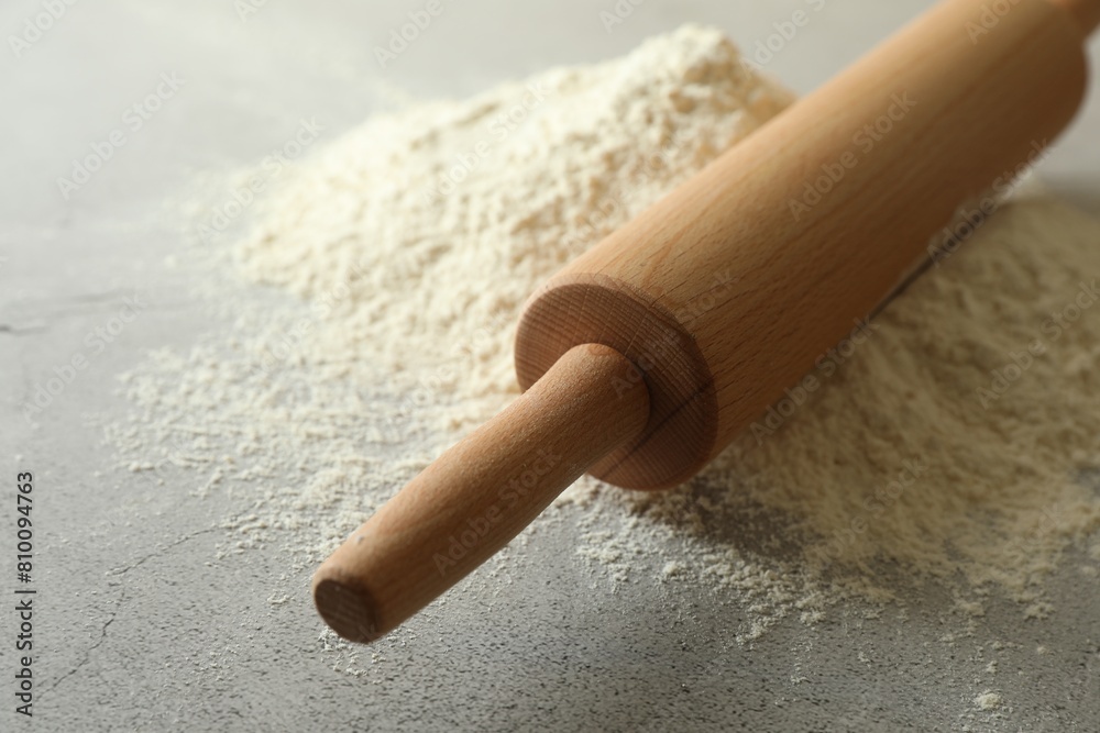 Flour and rolling pin on grey table, closeup Flour and rolling pin on grey table, closeup