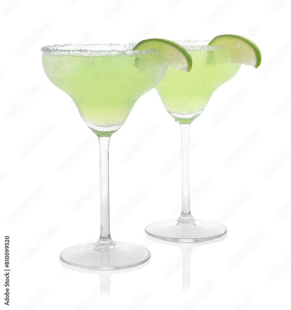Delicious Margarita cocktail in glasses, salt and lime isolated on white Delicious Margarita cocktail in glasses, salt and lime isolated on white