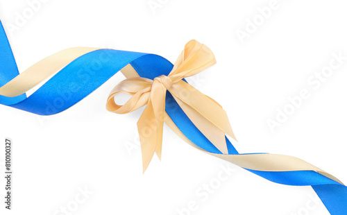 Golden and blue satin ribbons with bow isolated on white, top view
