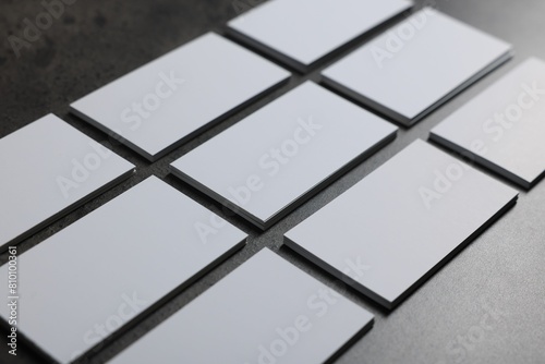 Blank business cards on grey textured table  closeup. Mockup for design