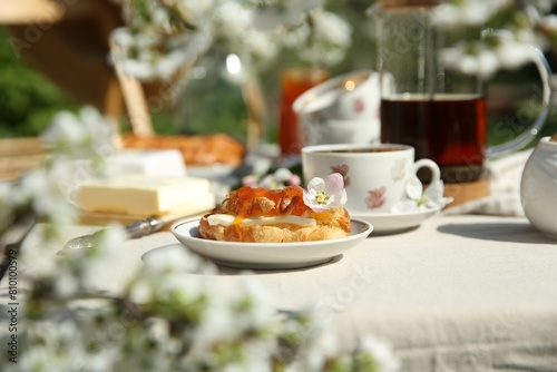 Beautiful table setting in spring garden on sunny day