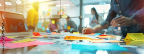 A group of people working together on a table surrounded by colorful sticky notes