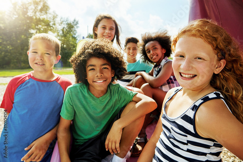 Children, park and portrait of group in summer to relax with friends on playground on vacation. Happy, holiday and kids together for party, games or smile outdoor at middle school on break at recess photo