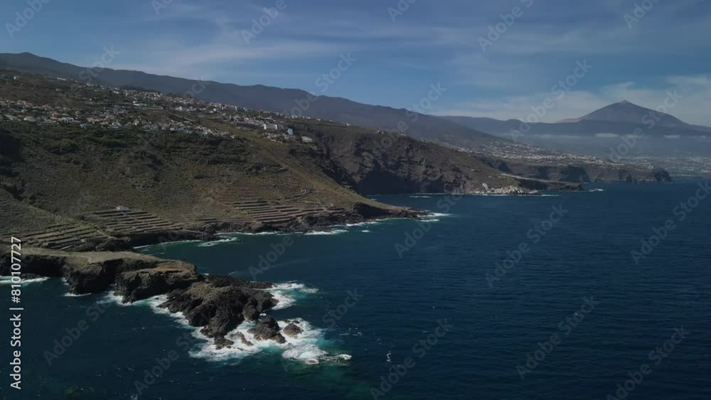 Fly over playa de rojas beach across rough coast with splashing waves Fly over playa de rojas beach across rough coast with splashing waves