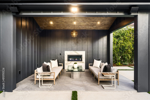 Covered Patio With Two Couches and Fireplace