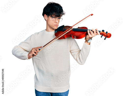 Handsome hipster young man playing violin skeptic and nervous, frowning upset because of problem. negative person. photo