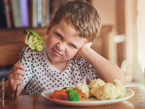 Tableau sur toile Upset, young boy and reject food at dinner table for not eating vegetable and no to nutrition at home