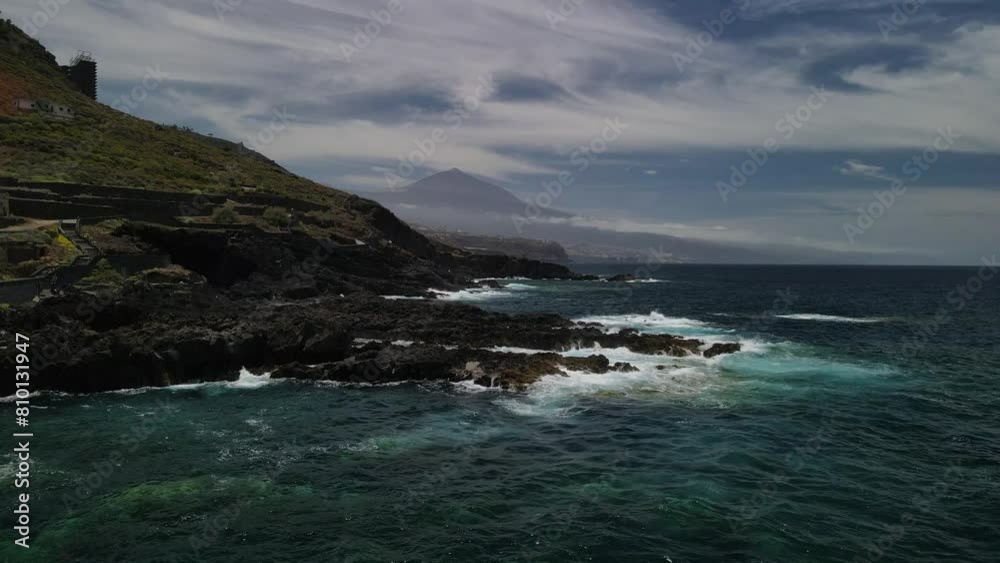 Fly over playa de rojas beach across rough coast with splashing waves Fly over playa de rojas beach across rough coast with splashing waves